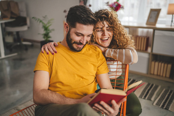 man and woman caucasian adult couple read books at home - Photo, Image