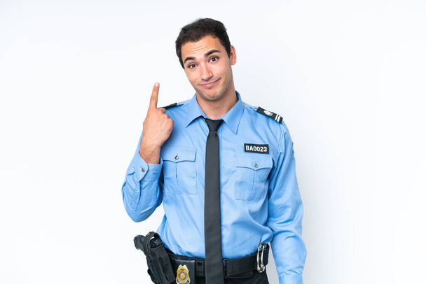 Young police caucasian man isolated on white background pointing with the index finger a great idea - Photo, Image
