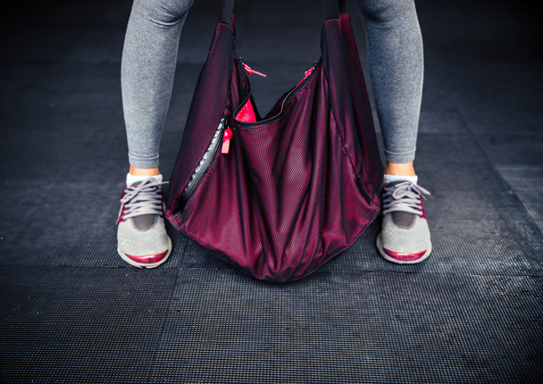 Female legs and sports bag - Фото, зображення
