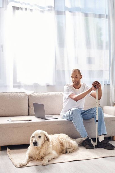 A disabled African American man relaxes beside his loyal Labrador dog on a comfortable couch, embracing diversity and inclusion. - Φωτογραφία, εικόνα