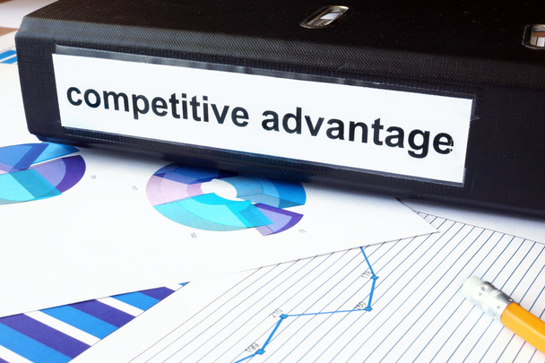 Graphs and file folder with label competitive advantage. - Фото, изображение