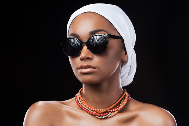 African woman wearing headscarf and sunglasses - Фото, изображение