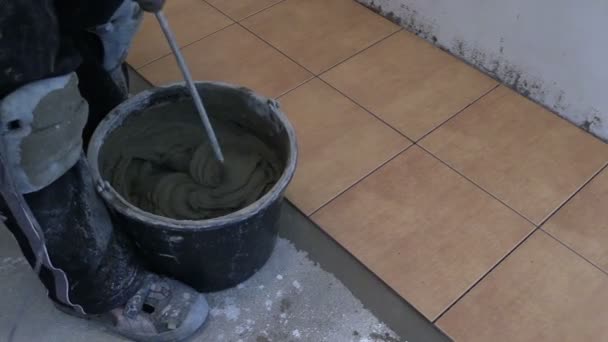 Hand mix tile cement with machine tool at kitchen - Footage, Video