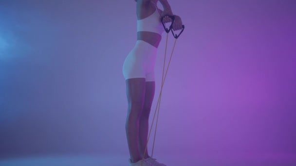 Functional training. Girl doing exercises in neon light. - Footage, Video