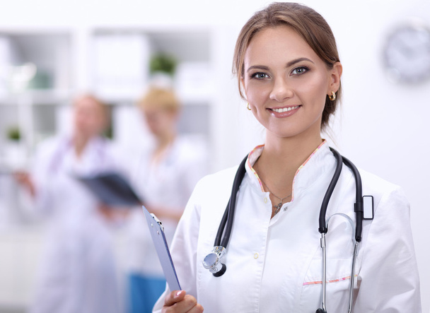 Portrait of woman doctor at hospital with folder - Photo, Image