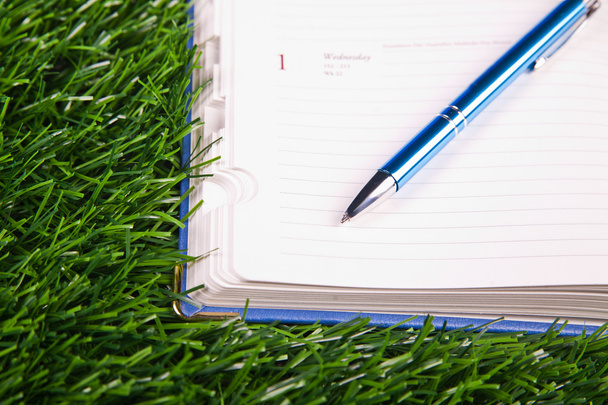 Notebook in the grass - Foto, immagini