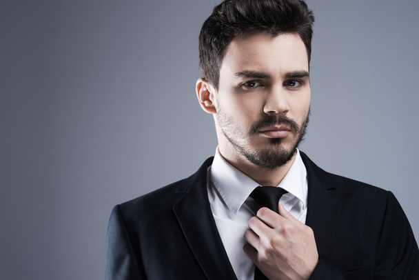 Man in formalwear adjusting necktie - Foto, immagini