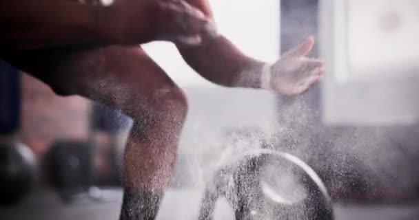 Man, hands and clapping chalk in weightlifting, grip or getting ready for workout, exercise or training, Closeup of active muscular male person or bodybuilder hitting powder for barbell preparation. - Footage, Video
