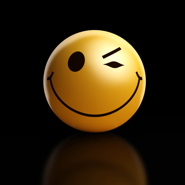 A winking smiley on a dark background - Photo, Image
