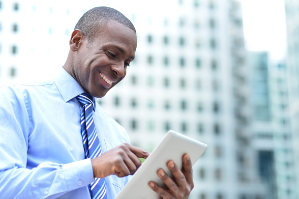 Businessman using his digital tablet - Фото, изображение