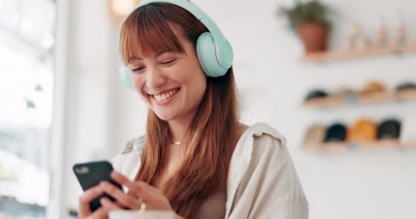Happy woman, phone and listening to music on headphones for social media, communication or networking. Female person, smile or laughing on mobile smartphone for funny joke, meme or online chatting. - Footage, Video