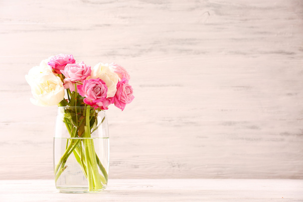 Bouquet of fresh roses and tulips on wooden background - Foto, imagen