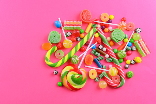 Colorful candies on pink background - 写真・画像