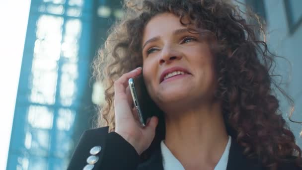 Close up beautiful business woman Caucasian young businesswoman girl happy female lady talking mobile phone pleasant smartphone conversation speaking cellphone communicate answer call outside in city - Footage, Video