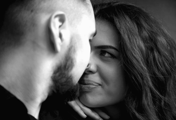 Long-awaited meeting of the two lovers.  Portrait of emotional young couple in love hugging each other. (happiness, love, romance, sensuality concept). Black and white image. - Photo, Image