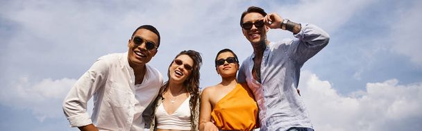 happy diverse attractive friends with trendy sunglasses posing actively on rooftop together, banner - Photo, Image