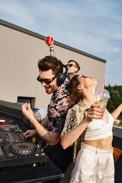 good looking joyous friends in festive urban attires dancing to DJ set at rooftop party together - Photo, Image