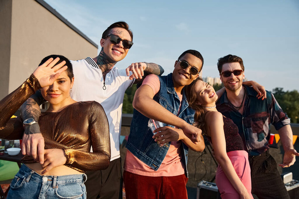 happy good looking diverse friends in stylish urban attires smiling at camera at rooftop party - Foto, Bild