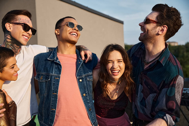 good looking diverse joyous friends with sunglasses having great time together at rooftop party - Foto, Imagem