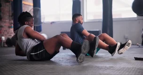 Man, personal trainer and medicine ball in fitness for exercise, workout or training on floor at gym. Active young male person in crunches with coach for muscle, strength or endurance at health club. - Footage, Video