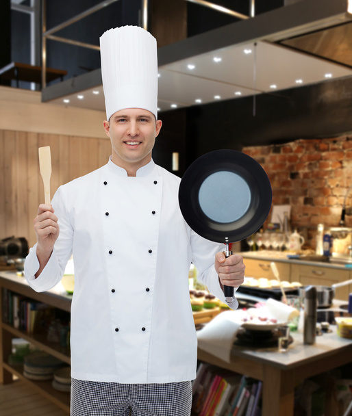 happy male chef holding frying pan and spatula - Foto, immagini