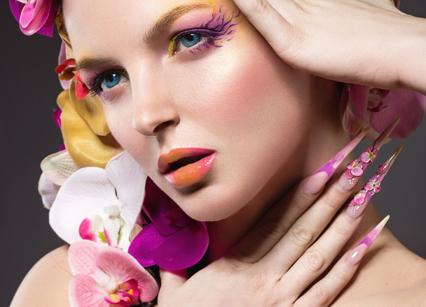 Beautiful woman with long nails, perfect skin, hair of orchids. - Foto, immagini