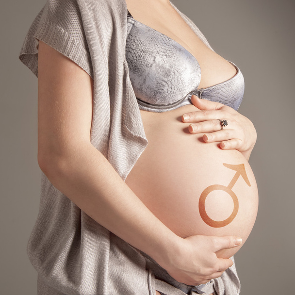 Беременная женщина с символом
 - Фото, изображение