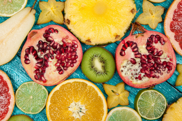 Fette di frutta colorate sulla superficie di legno blu
 - Foto, immagini