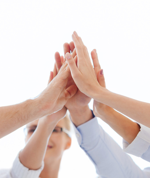 happy business team giving high five in office - Photo, image