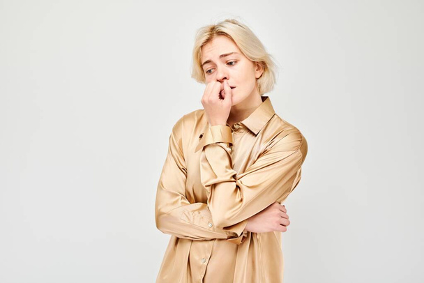 Portrait of girl with sad face worried, biting nails on white background. Nerves, stress, uncertainty concep - Valokuva, kuva