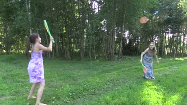 Happy pregnant mother with daughter play badminton game - Footage, Video