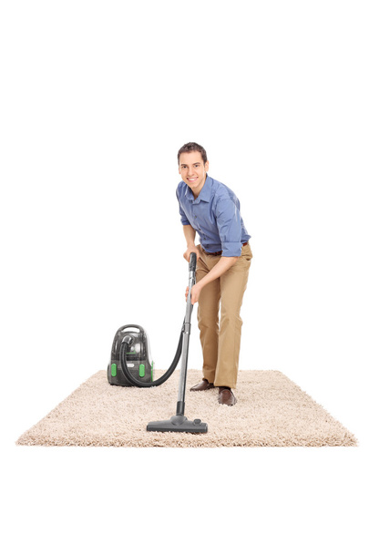 Man cleaning with a vacuum cleaner - Foto, immagini