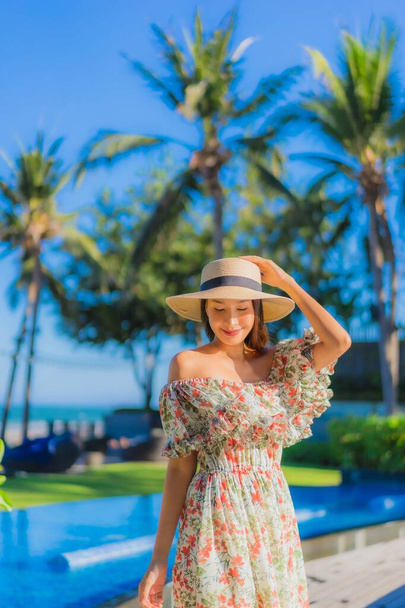 Portrait belle jeune femme asiatique sourire heureux se détendre autour de la plage tropicale mer océan sur ciel bleu pour les loisirs - Photo, image