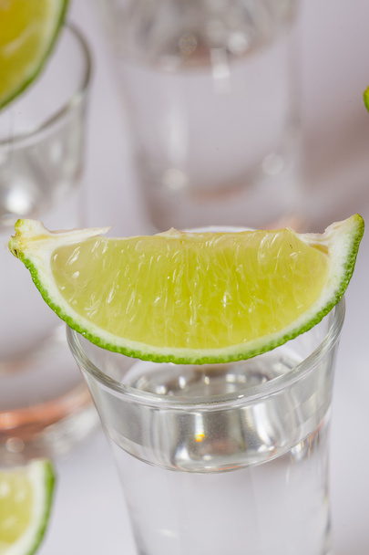 Tequila in glass on white - 写真・画像