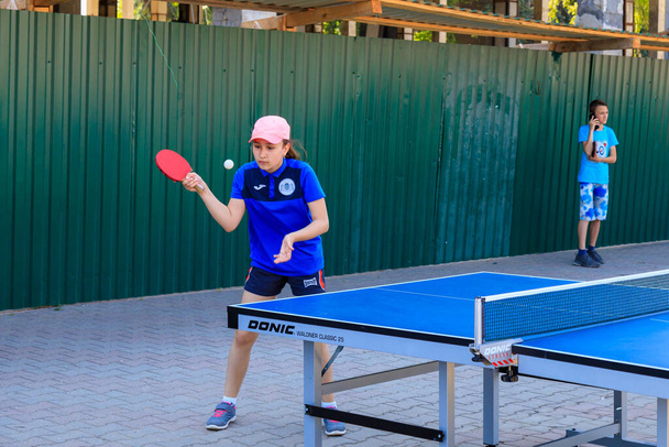 June 1, 2022 Beltsy, Moldova. For illustrative editorial use. Girl playing table tennis on the street - Photo, Image