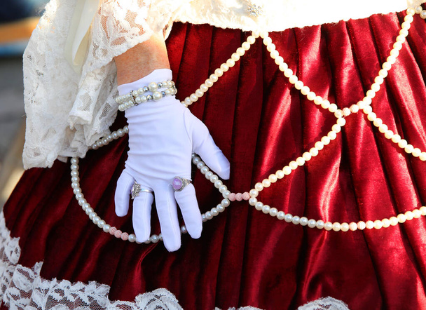 hand of woman with ancient expensive dress with white glove and rings on the hand - Photo, Image