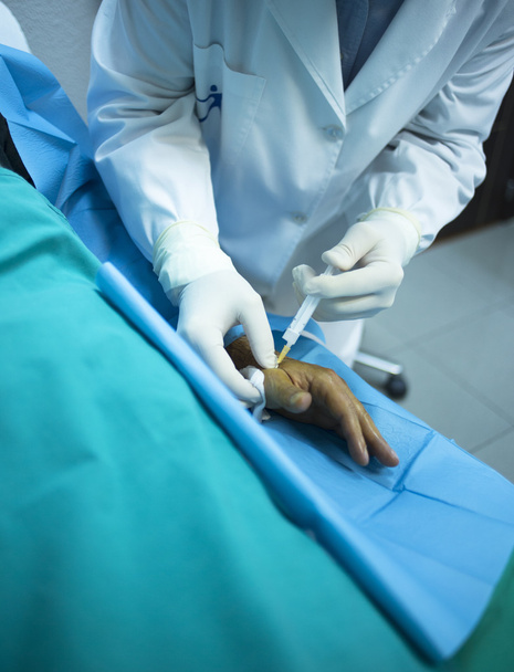 Médico cirujano inyectando paciente en clínica hospitalaria
 - Foto, Imagen