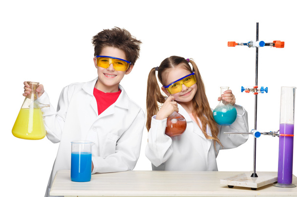 Two cute children at chemistry lesson making experiments - Zdjęcie, obraz