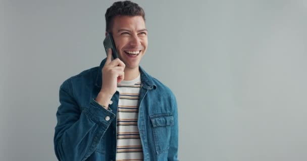 Phone call, mockup and happy man in studio speaking, listening or web communication on grey background. Smartphone, conversation and male model smile for contact chat, gossip or friendly discussion. - Footage, Video