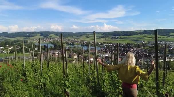 Девушка, прогуливающаяся по террасным виноградникам над Штайн-ам-Райн в Швейцарии. Вид с воздуха на городской пейзаж на Рейн. Швейцарский кантон Шаффхаузен. Понятие беззаботной и естественной жизни. Медленное движение - Кадры, видео