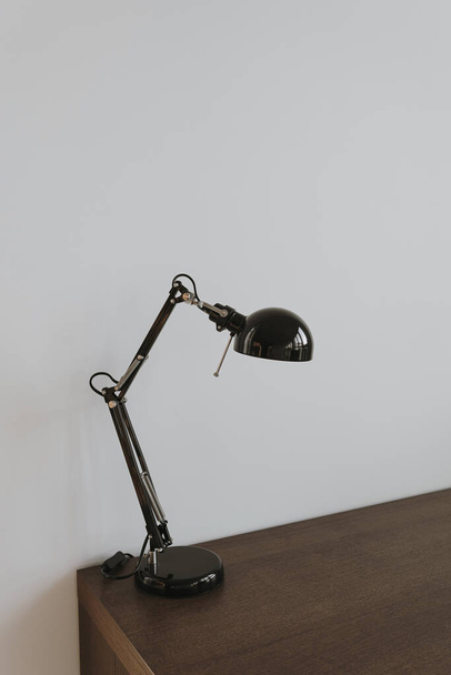 Lamp on wooden table near white wall - Photo, Image