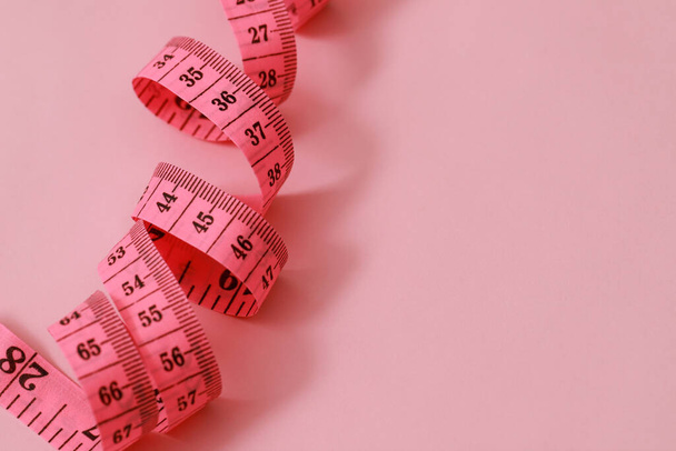 tape measure for obese people on a pink background soft focus - Photo, Image