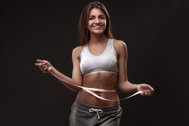 Sporty woman with measurment tape - Foto, Imagem