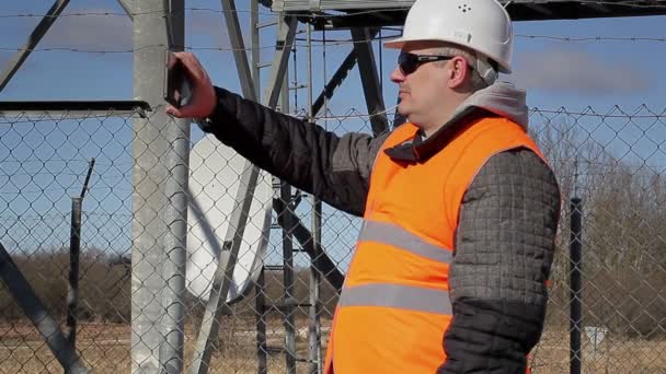 Engineer filmed at outdoors near metal structures - Footage, Video