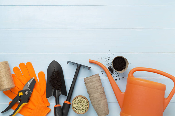 Orange gardening tools on wooden background, top view - Photo, Image