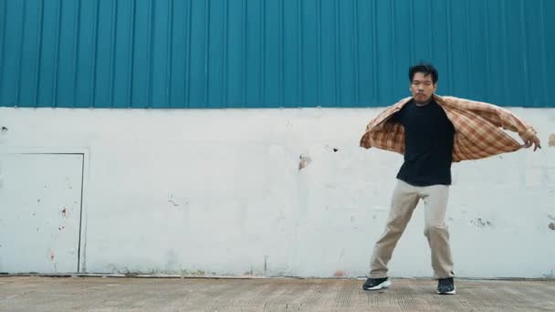 Hispanischer Choreograph, der im Hip-Hop-Stil tanzt. Junge fröhliche Breakdancer führen B-Boy-Tanz auf. Bewegungsaufnahme eines lustigen Mannes, der Straßentanz praktiziert. Outdoor-Sport 2024. Moderner Tanz. hiphop. - Filmmaterial, Video