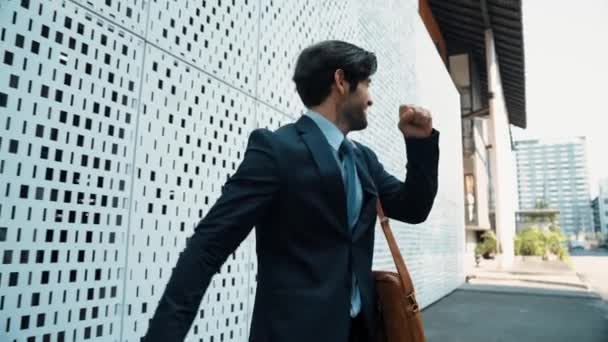 Happy smart business man celebrate for successful startup project while walking at white building. Successful project manager dancing overjoy while receive good news about getting promotion. Exultant. - Footage, Video