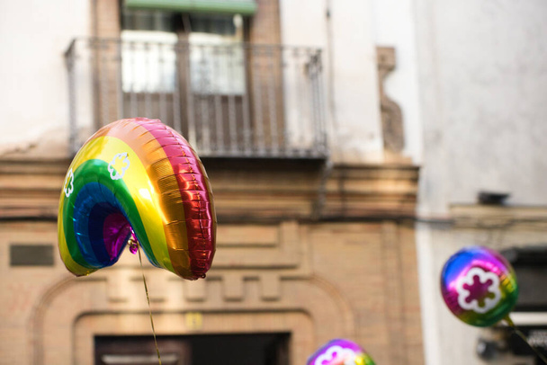 Des ballons survolent la fierté gay lors de la manifestation pour les droits des homosexuels et des personnes LGBTQ dans la ville de Séville, en Espagne. Concept d'égalité et droits des homosexuels - Photo, image