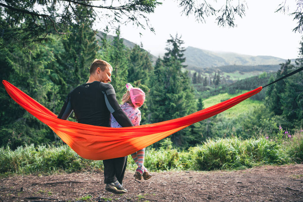 père heureux avec la fille sur des montagnes d'hamac sur l'espace de copie de fond - Photo, image