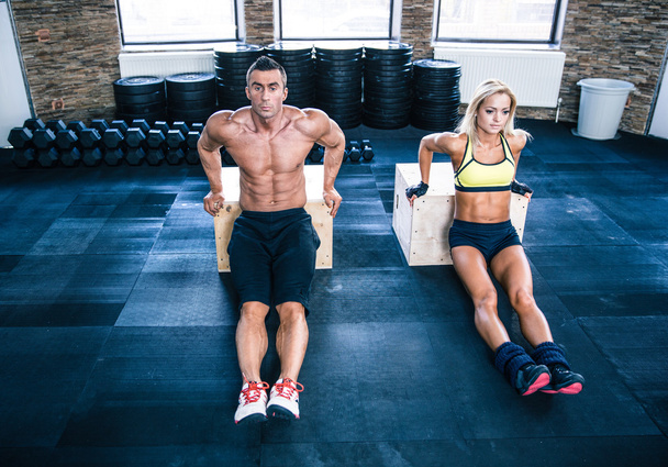 Man and woman workout with hands on fit box - 写真・画像